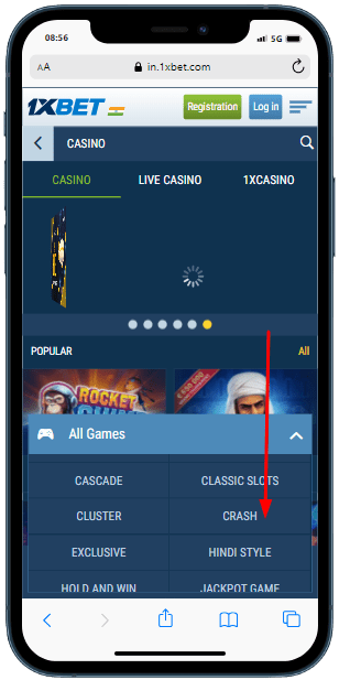A smartphone showing All games section on the 1xbet site, and arrow which points for 'Crash'