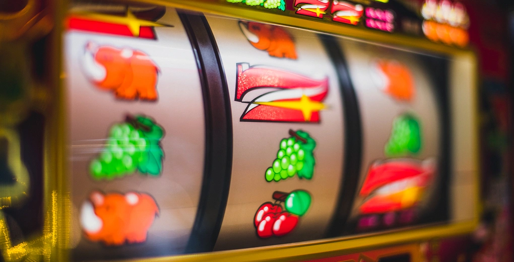 Close-up of spinning fruit slot reels displaying vibrant symbols in motion